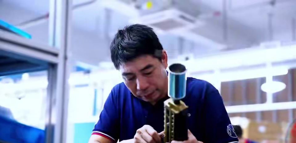 Worker assembling a butane torch valve stack