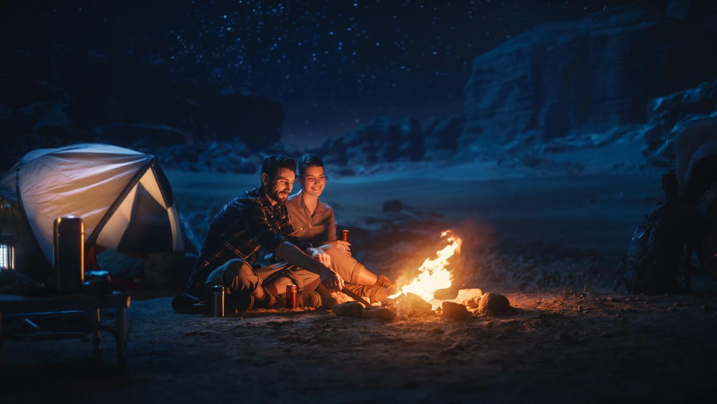 Campfire lit with a gas torch at a campsite
