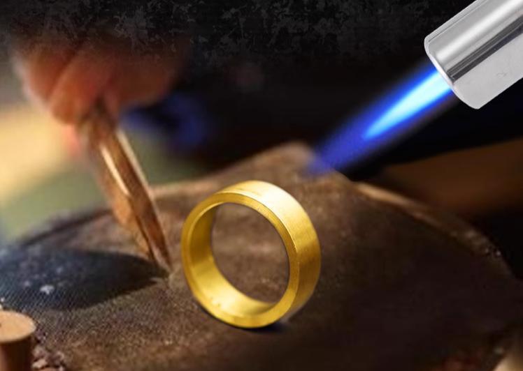 Butane torch flame soldering a gold ring